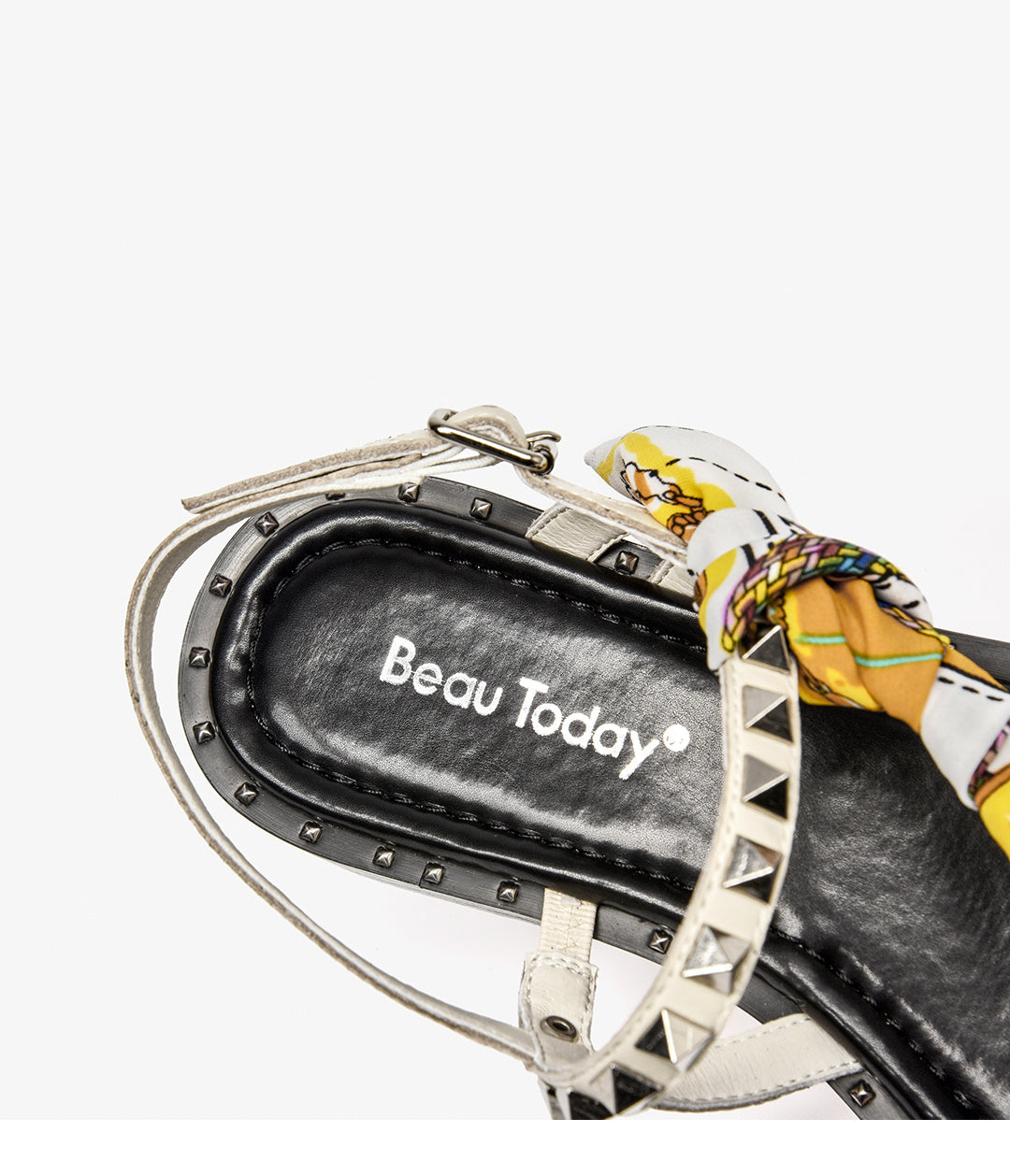 Black sandal with decorative strap and 'Beau Today' branding on a white background