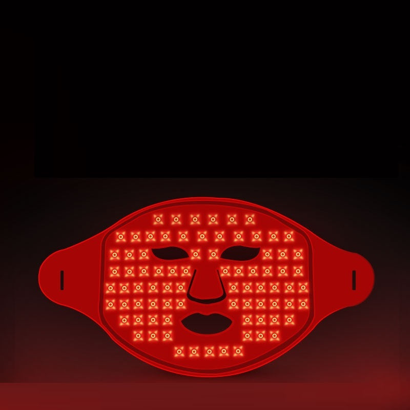 Red LED face mask on a dark background