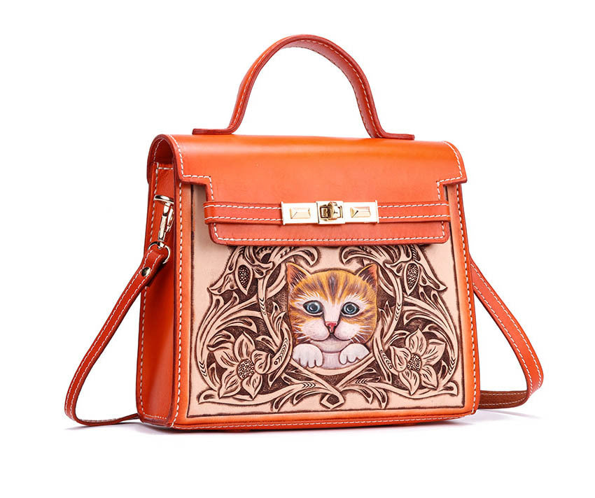 Orange handbag with a cat design on a white background