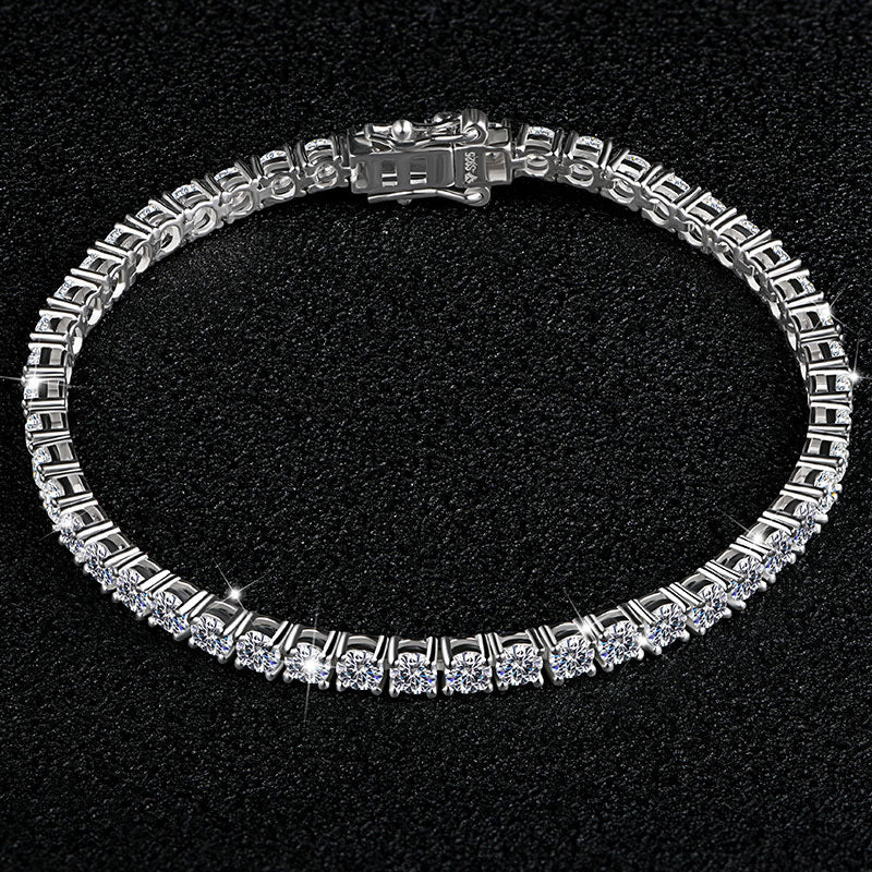 Silver bracelet with clear stones on a black background