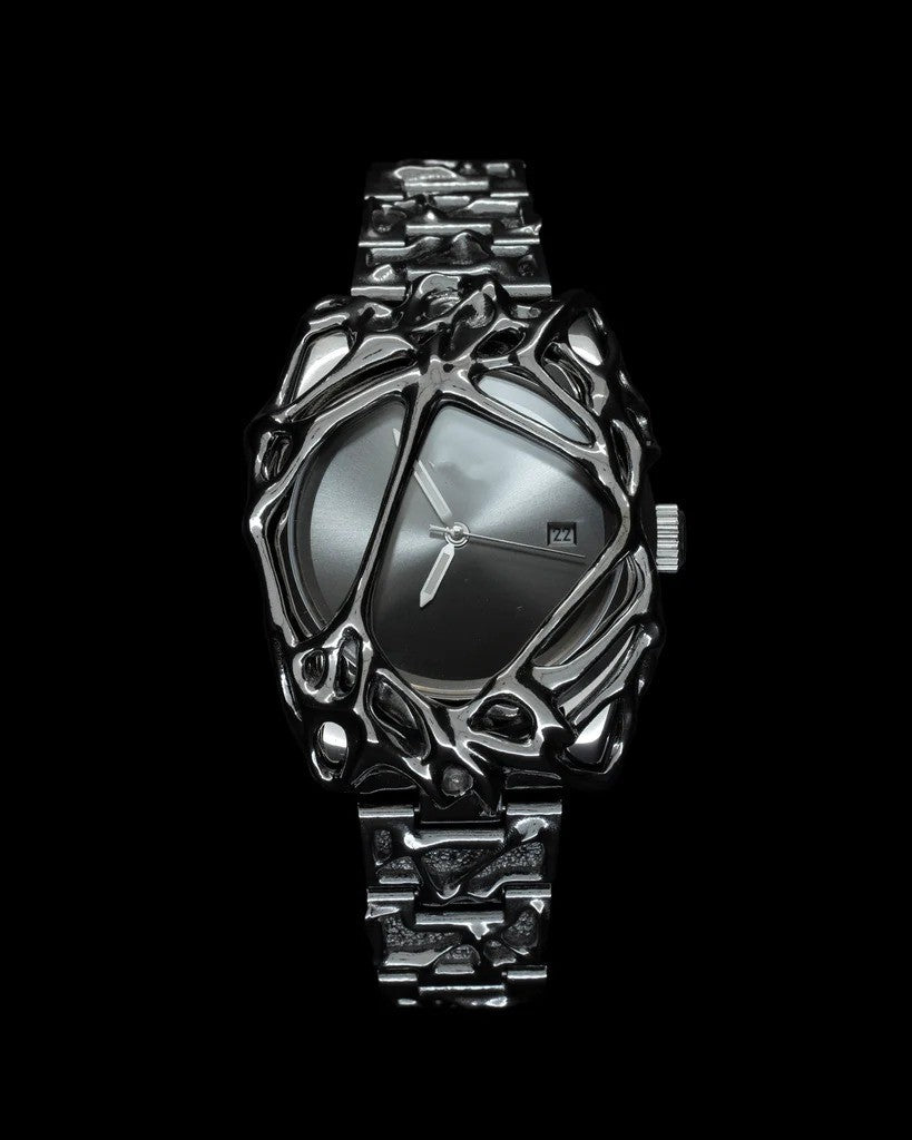 Futuristic silver watch with intricate design on a black background