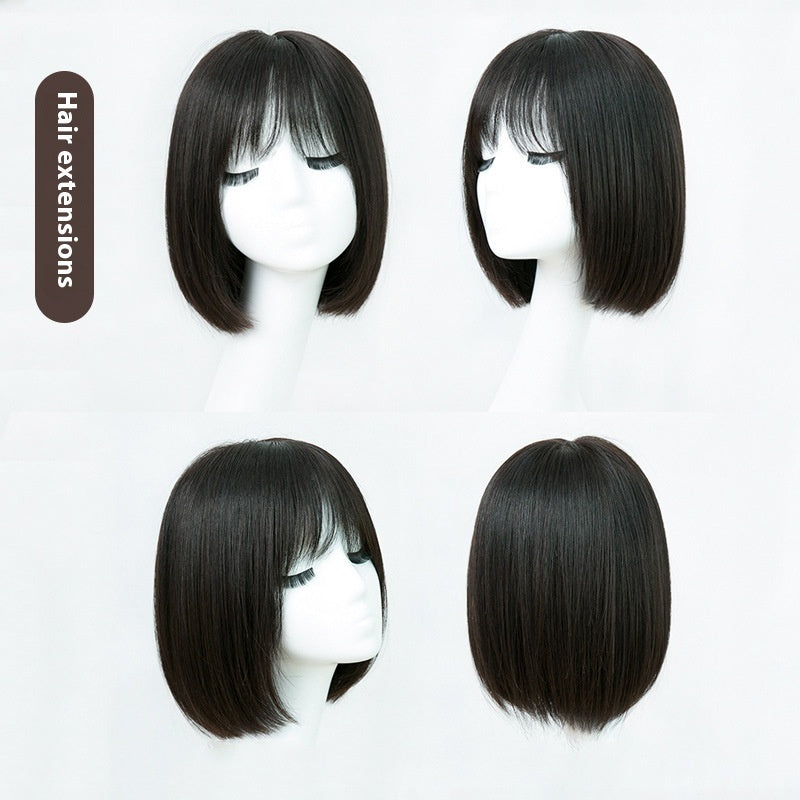 Four black hair extensions on mannequin heads with a white background.