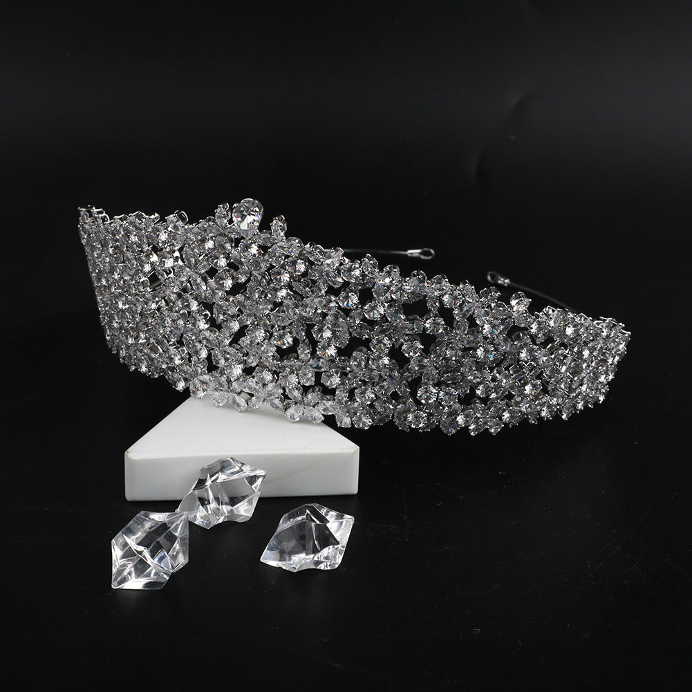 Silver tiara with clear crystals on a black background