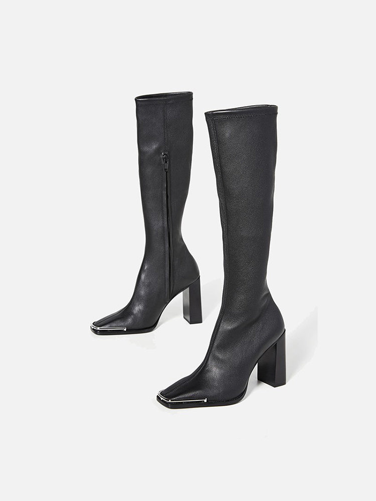 Pair of black knee-high boots on a white background