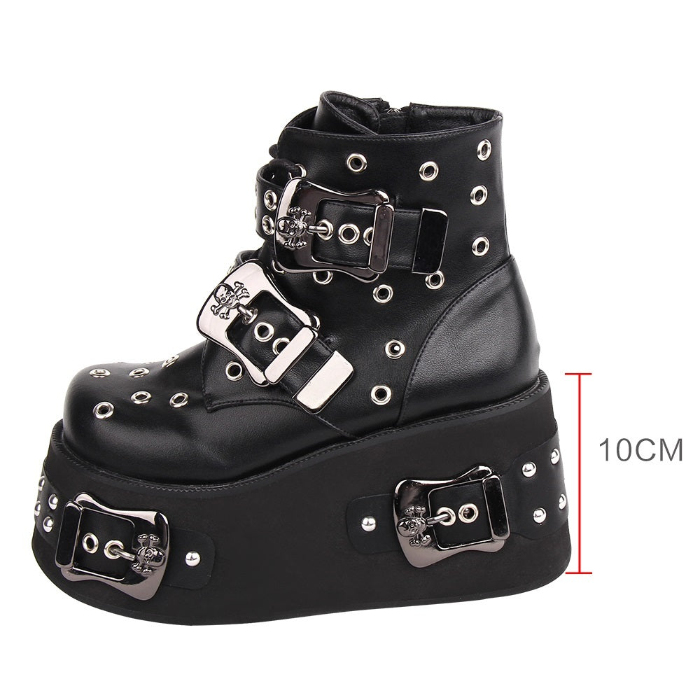 Black platform boot with silver buckles and studs on a white background