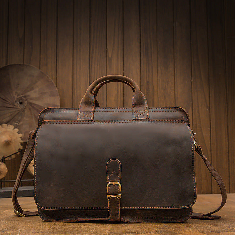 Brown leather briefcase on a wooden surface with a wooden panel background