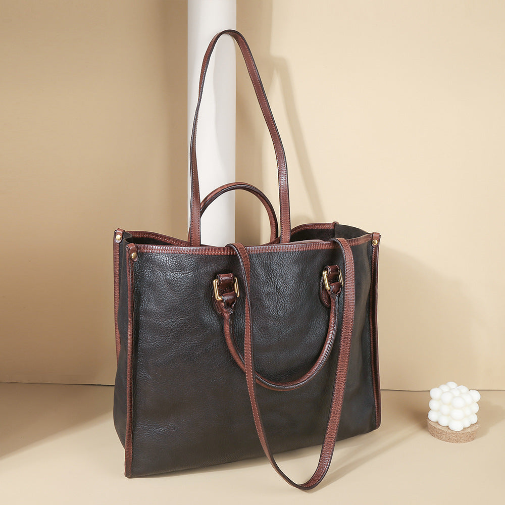 Brown leather tote bag on a beige background