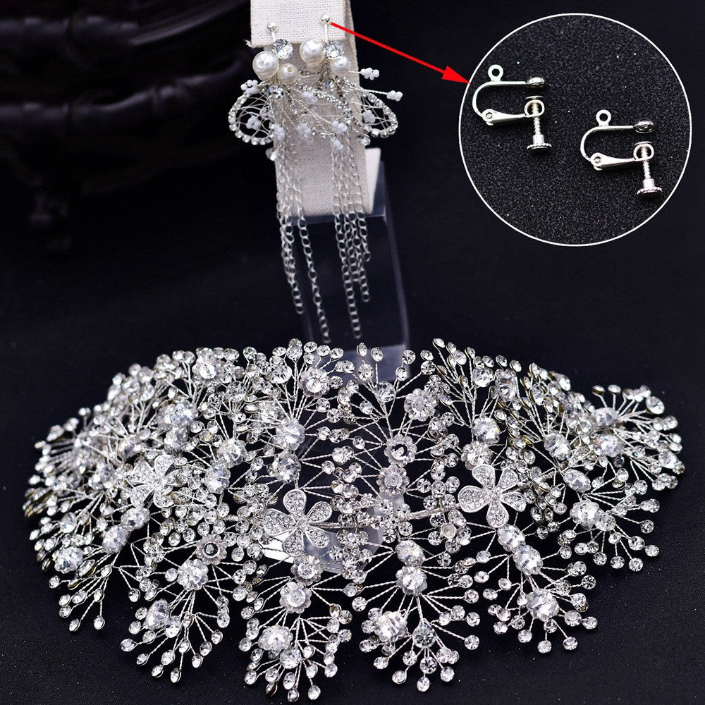 Silver hairpiece with intricate design on a black background