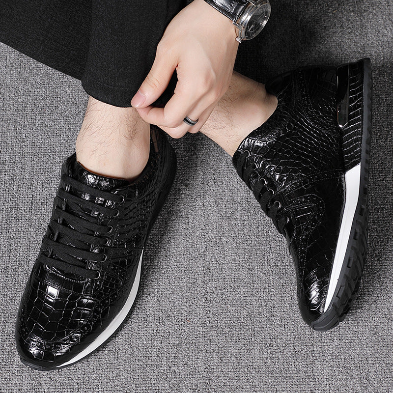 Person wearing black textured sneakers on a gray surface