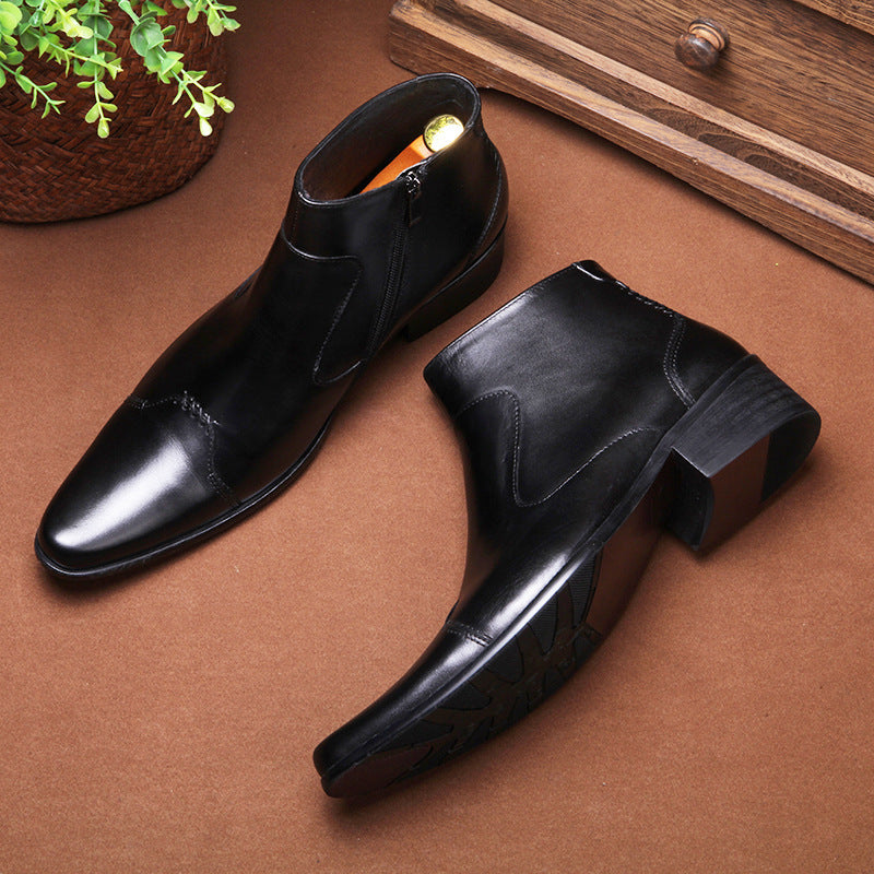 Pair of black dress shoes on a brown surface with a wooden drawer in the background.