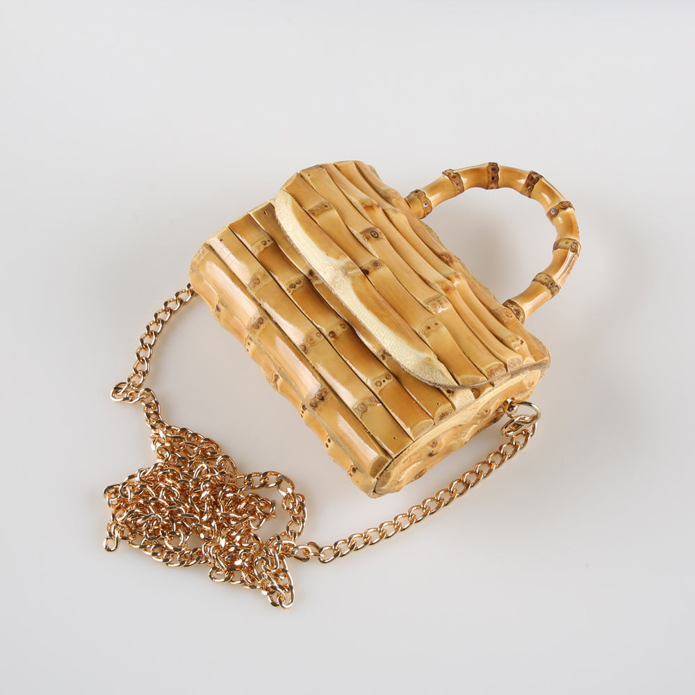 Bamboo handbag with a gold chain on a white background