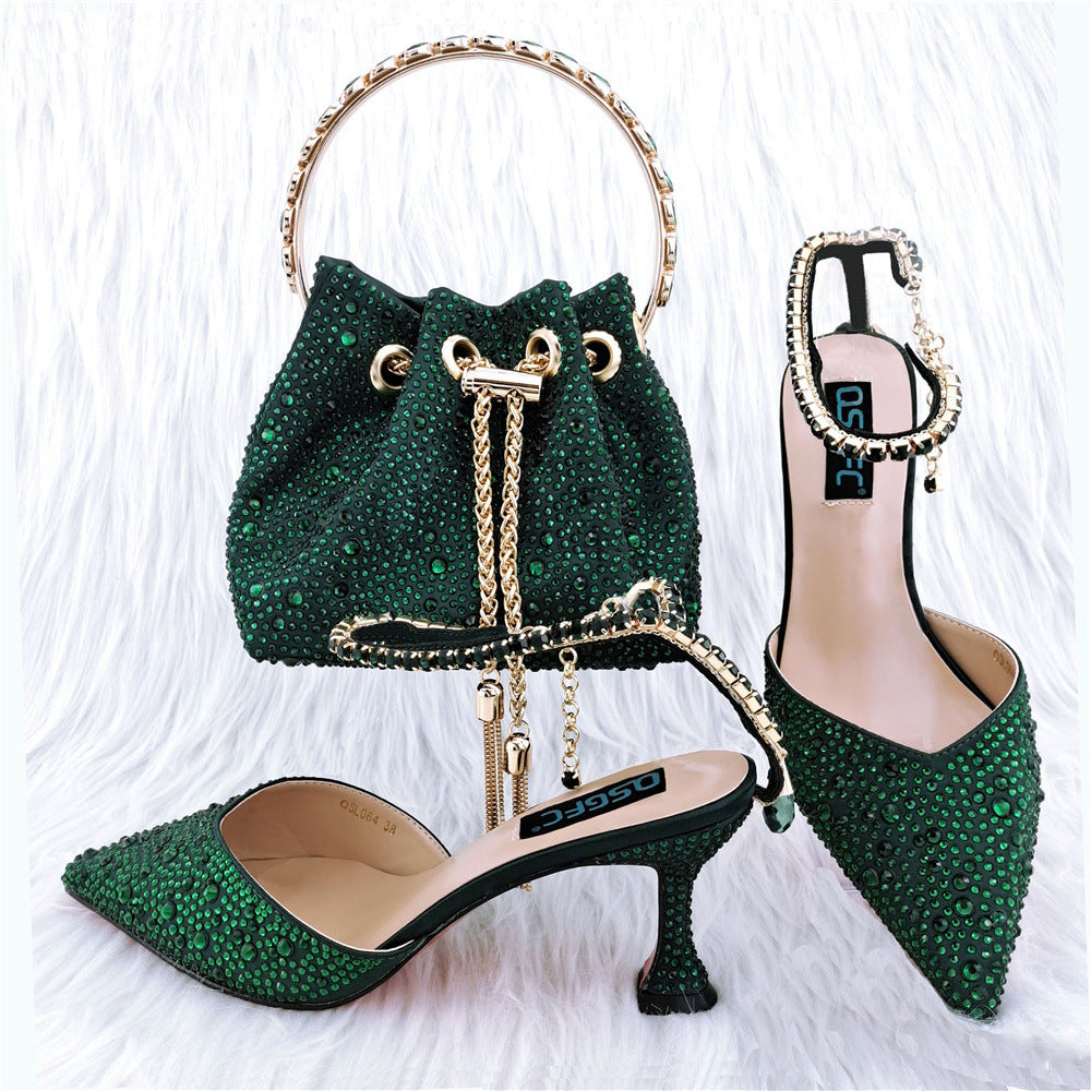 Green studded handbag and high heels on a white background