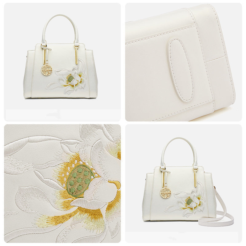 White handbag with floral embroidery on a white background