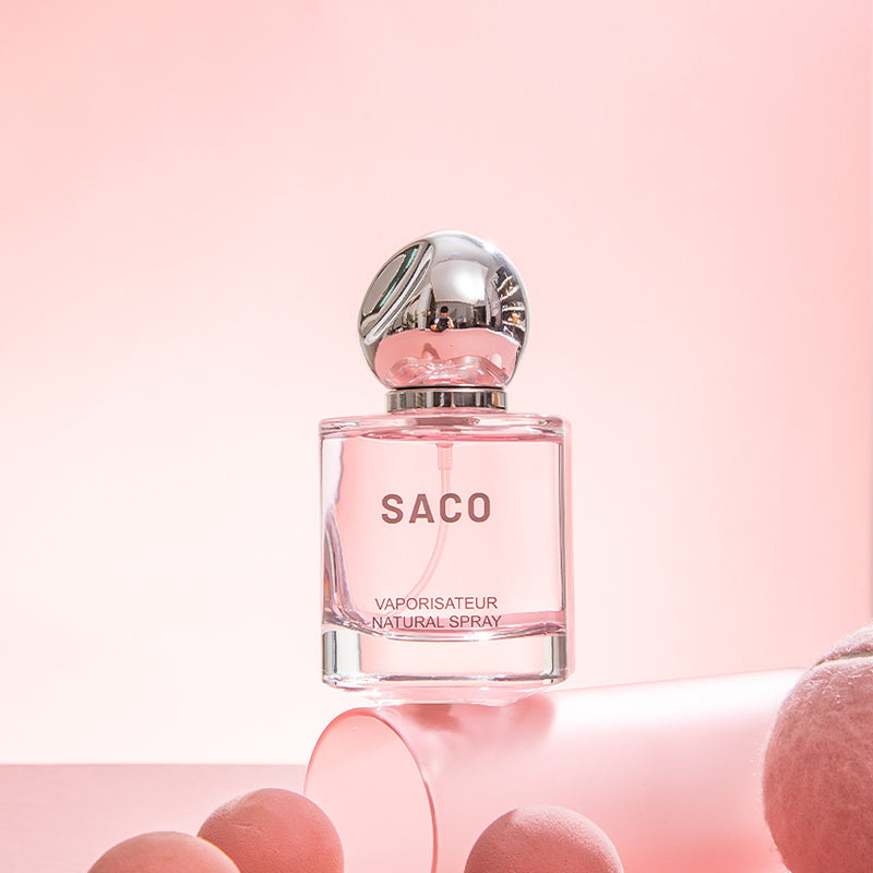Pink Saco perfume bottle on a pink background