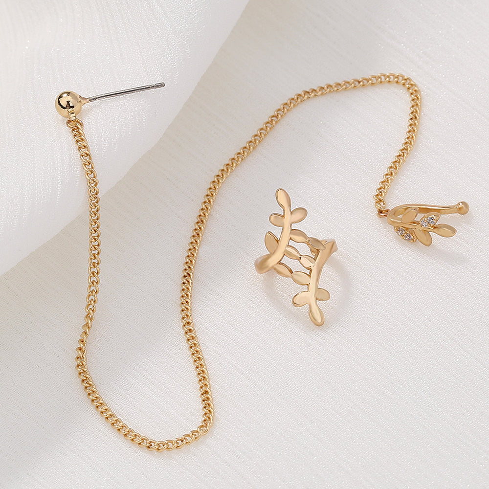 Gold chain necklace and earrings on a light background