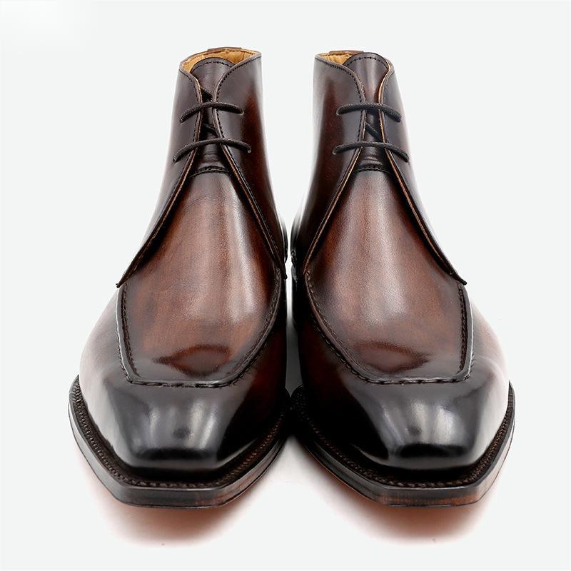 Pair of brown leather boots on a white background