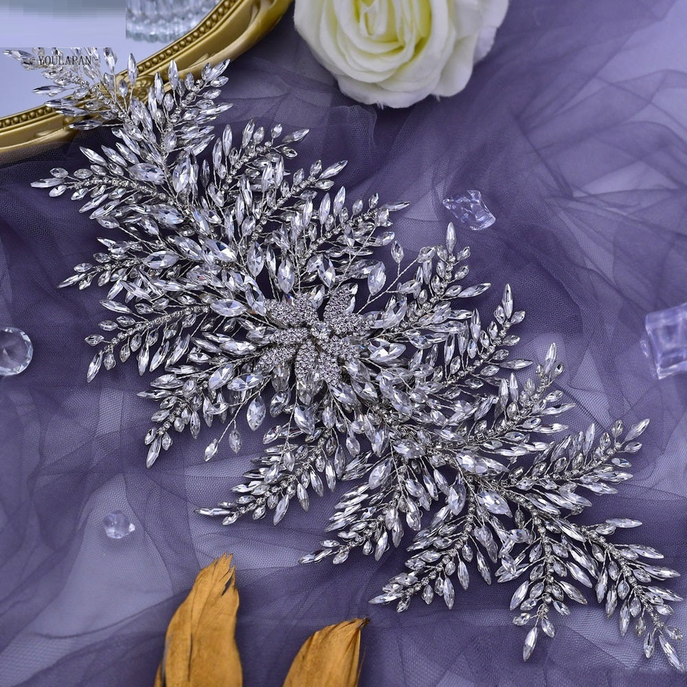Decorative silver leaf embellishment on a purple fabric background
