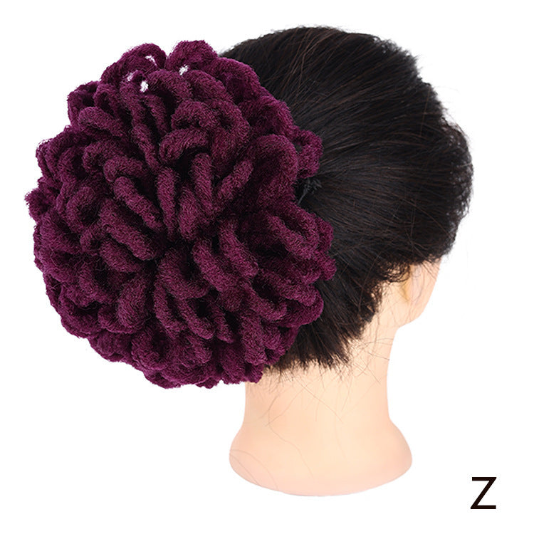 Purple textured hair bun cover on a mannequin head against a white background