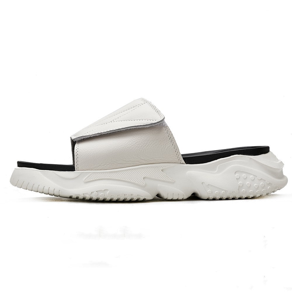 White slide sandal with black sole on a white background