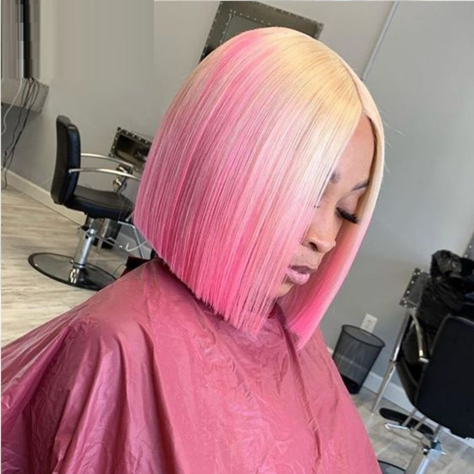 Person with pink and blonde ombre hair in a salon setting
