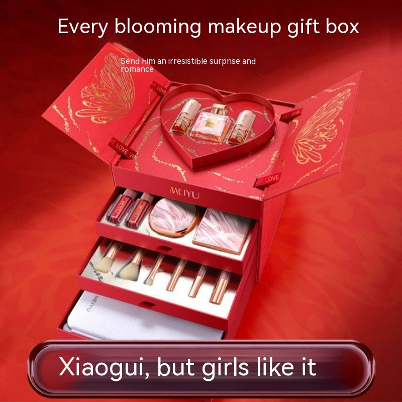 Red makeup gift box with various items on a red background