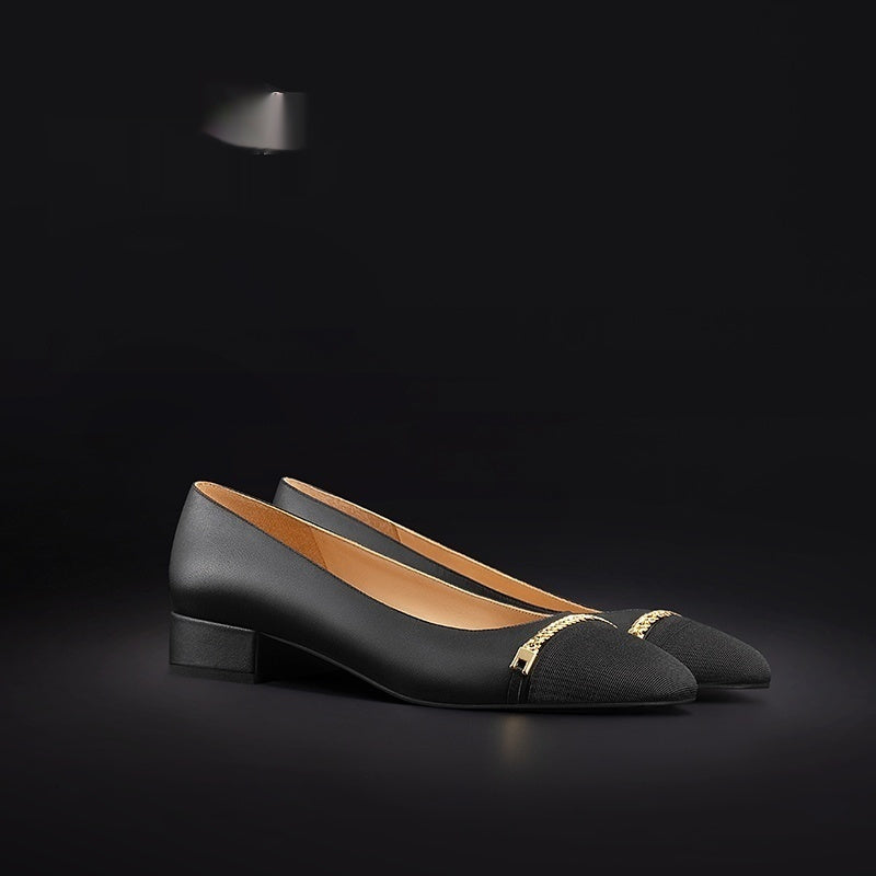 Black shoes with gold accents on a black background