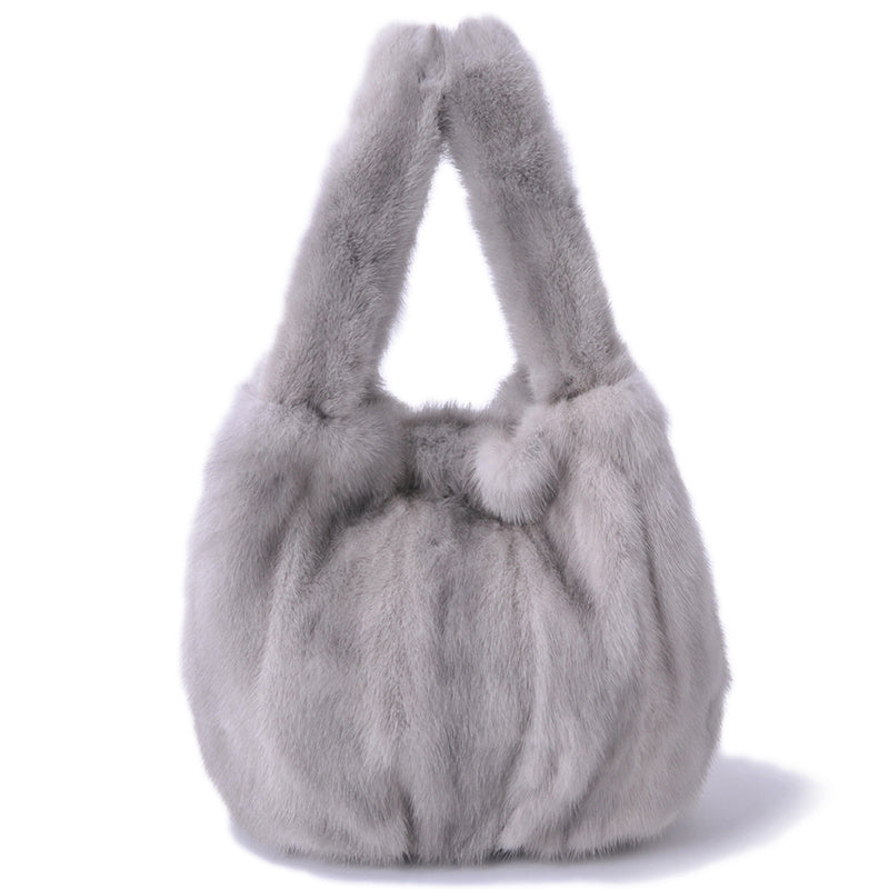 Gray fur handbag on a white background