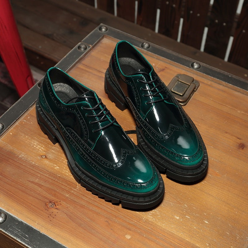 Green leather shoes on a wooden surface with a metal latch