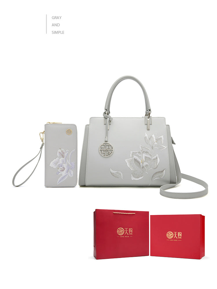 White handbag with floral designs and matching pouch, displayed with red boxes on a white background.