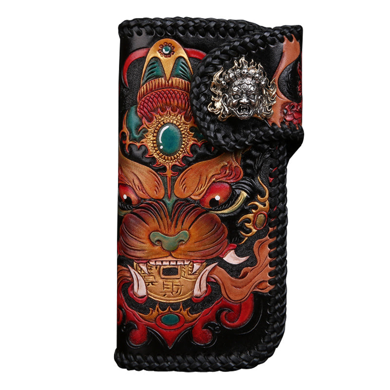 Decorative leather case with intricate designs and a braided handle on a white background