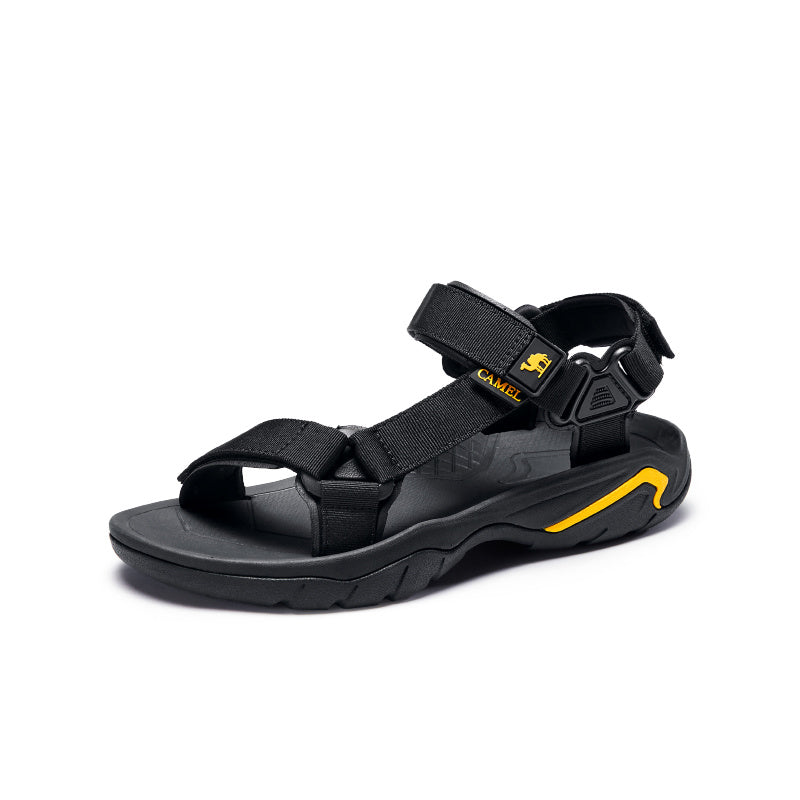 Black sandal with yellow accents on a white background