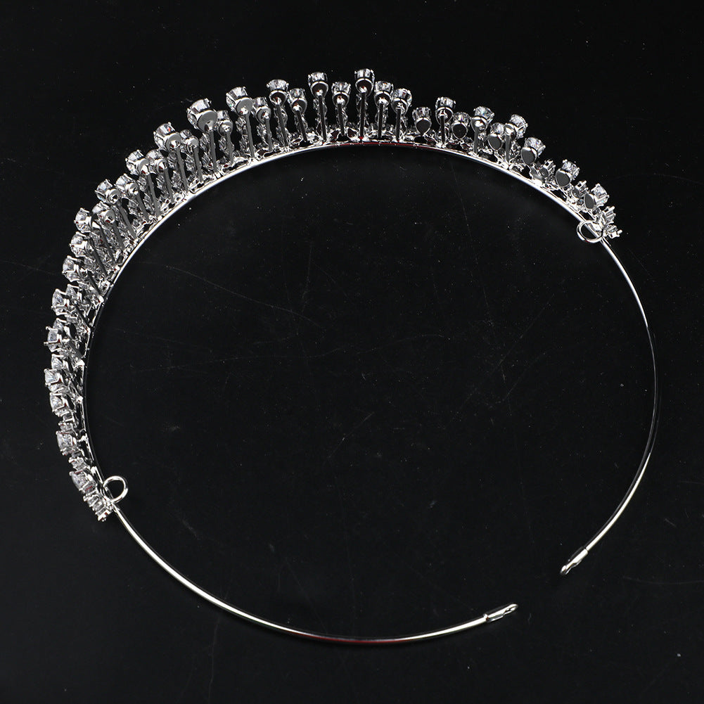 Silver tiara with clear stones on a black background