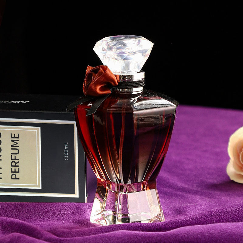 Perfume bottle with a diamond-shaped cap on a purple surface