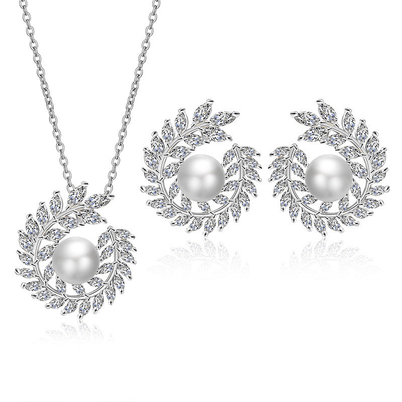 Jewelry set with pearl necklace and earrings on a white background