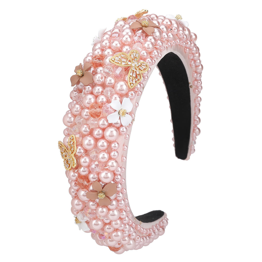 Pink pearl headband with decorative butterflies on a white background