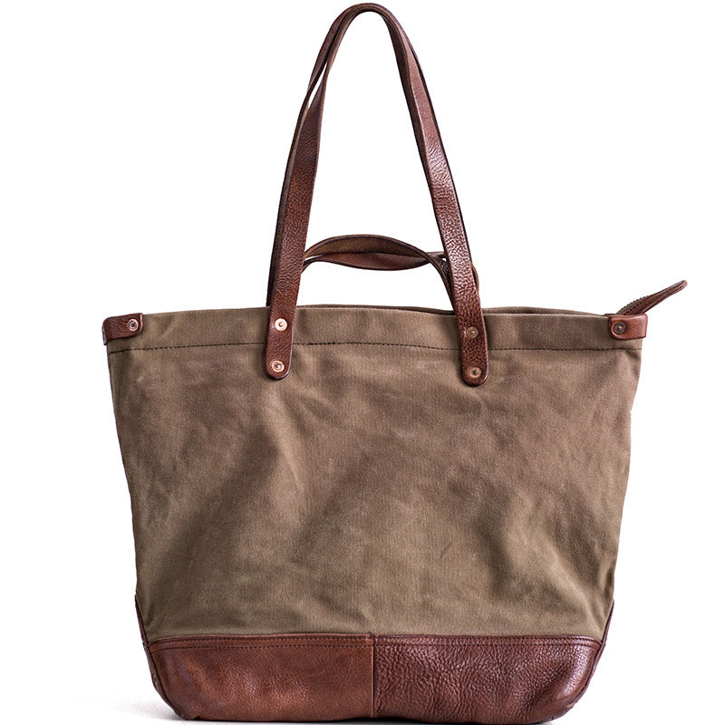 Brown tote bag with leather accents on a white background