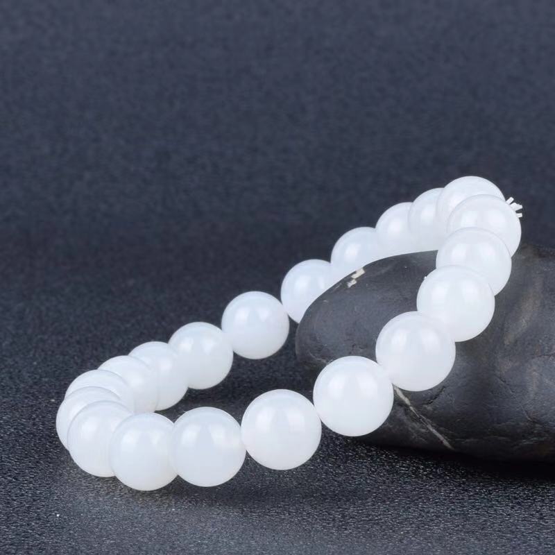 White beaded bracelet on a dark textured background