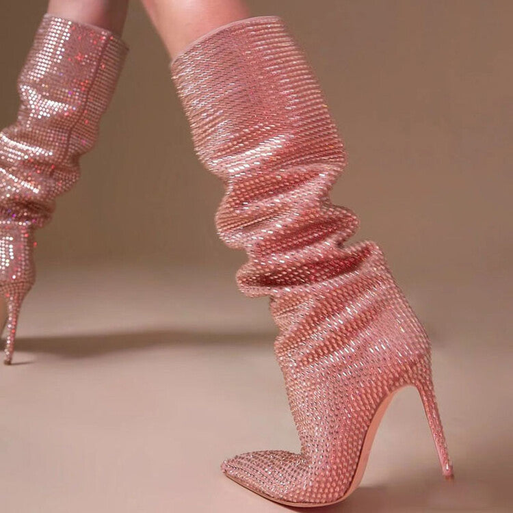 Pink glittery high-heeled boots on a beige background