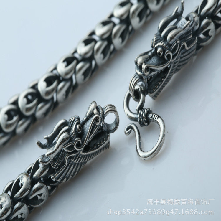 Silver dragon-themed bracelet on a light gray background