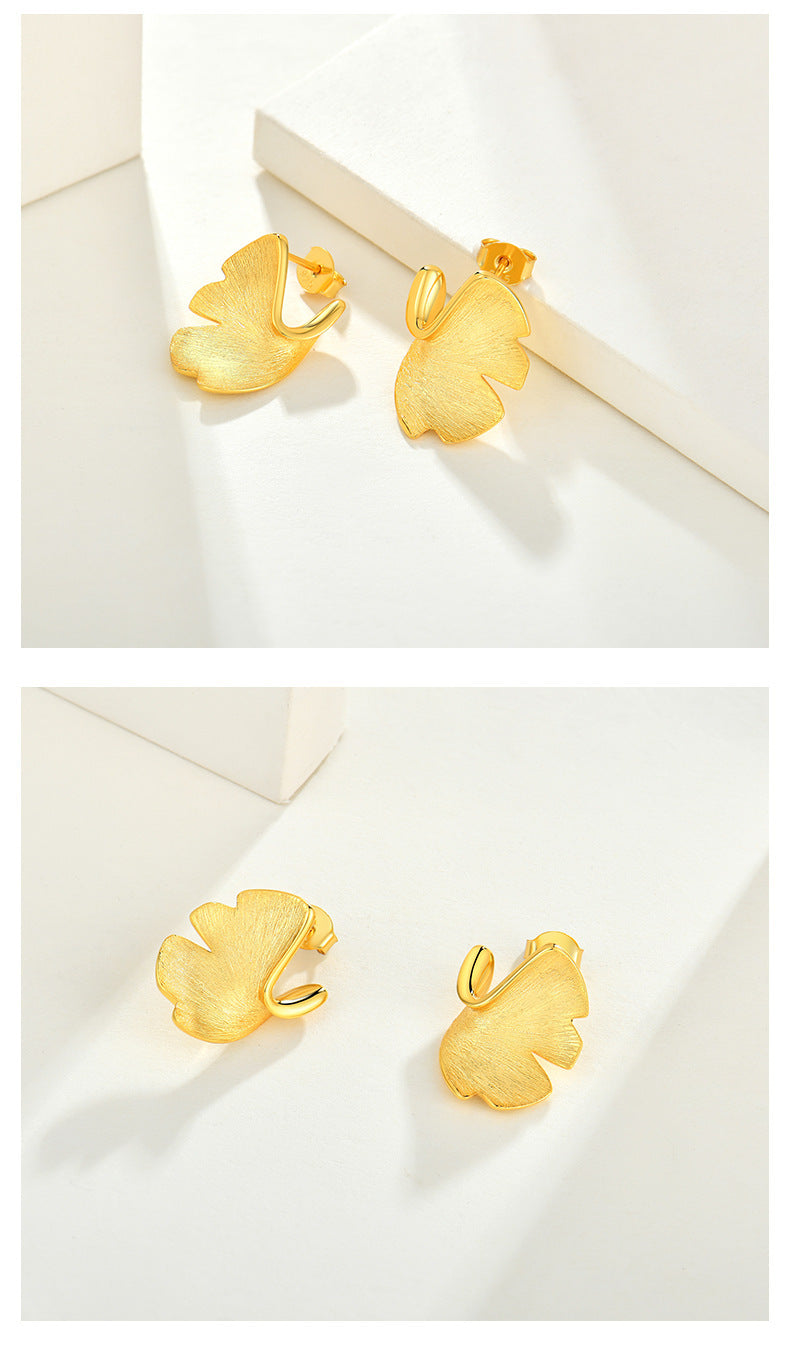 Gold earrings on a white background