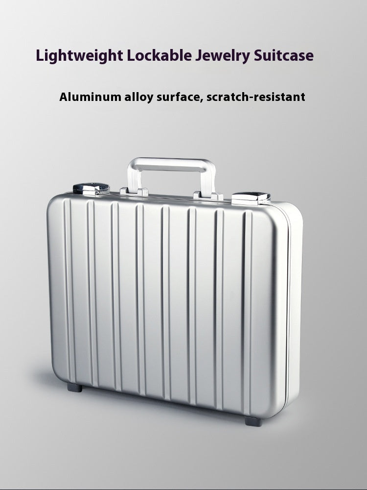 Lightweight lockable jewelry suitcase with aluminum alloy surface on a gray background