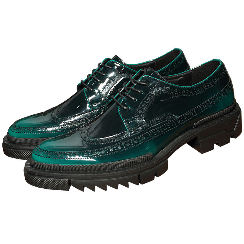Green glossy shoes with black soles on a white background
