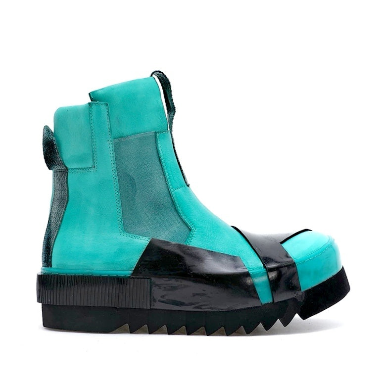 Turquoise and black boot on a white background