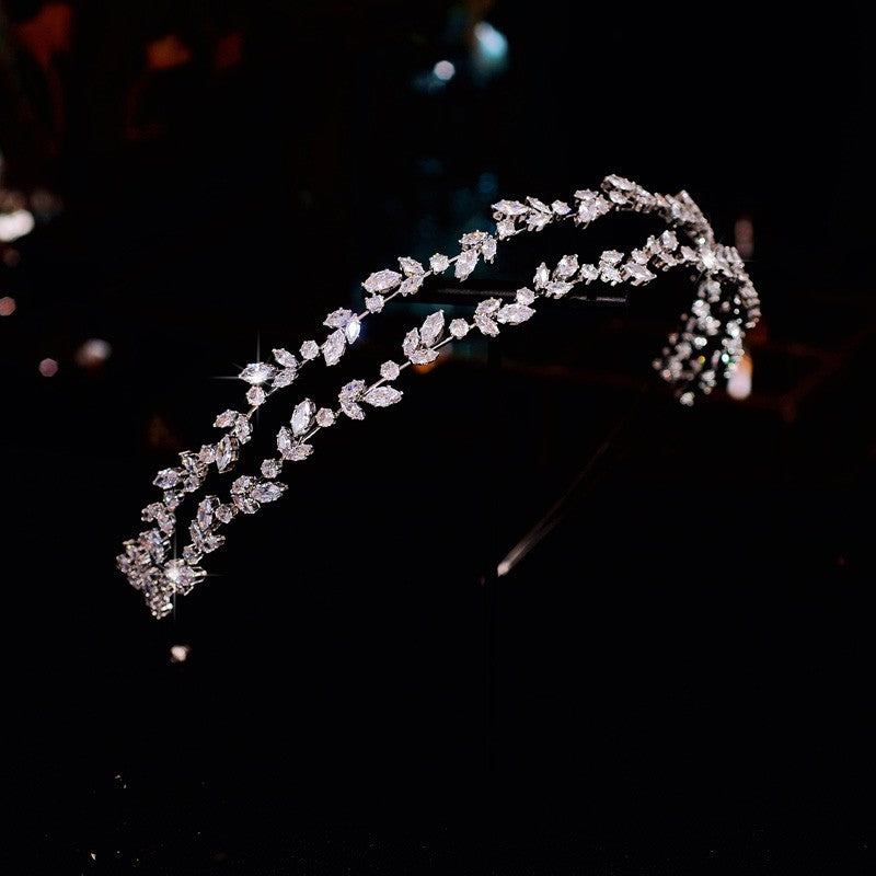 Silver headband with crystals on a dark background