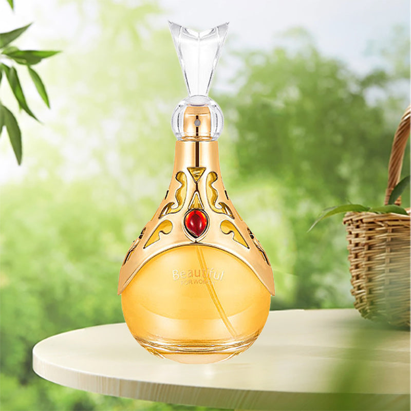 Decorative bottle with gold and red design on a blurred green background
