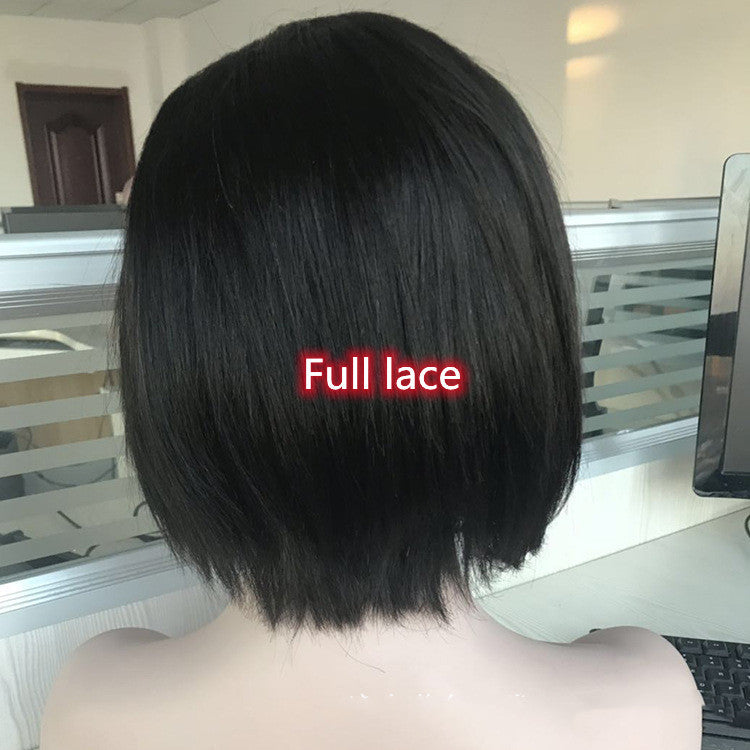 Black wig on a mannequin head with 'Full lace' label in a room setting.