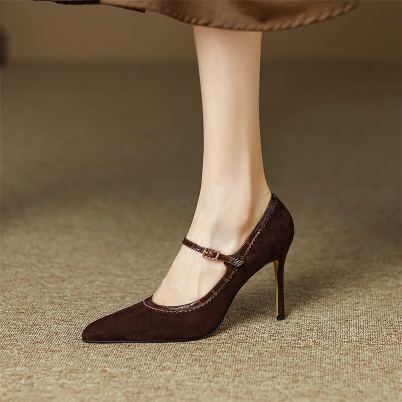 Brown high-heeled shoes worn by a person on a textured surface