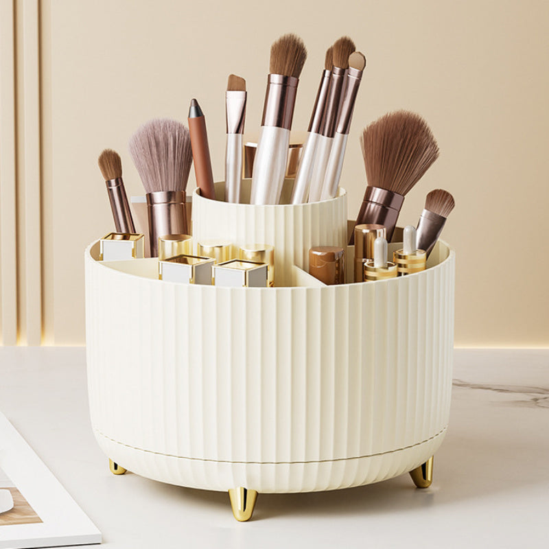 White cylindrical makeup brush holder with various brushes on a light background