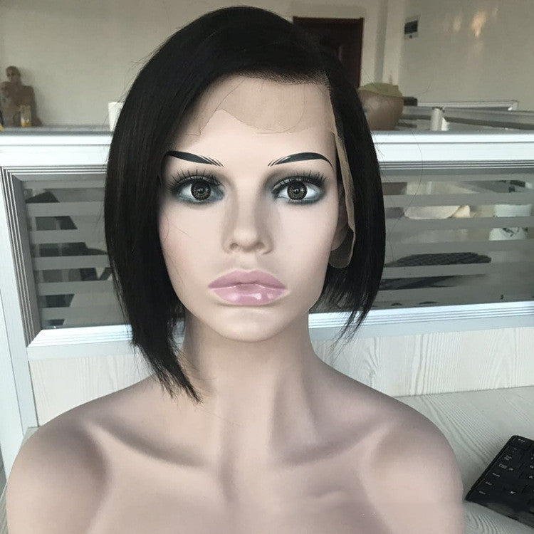 Mannequin head with black hair and makeup in a room setting