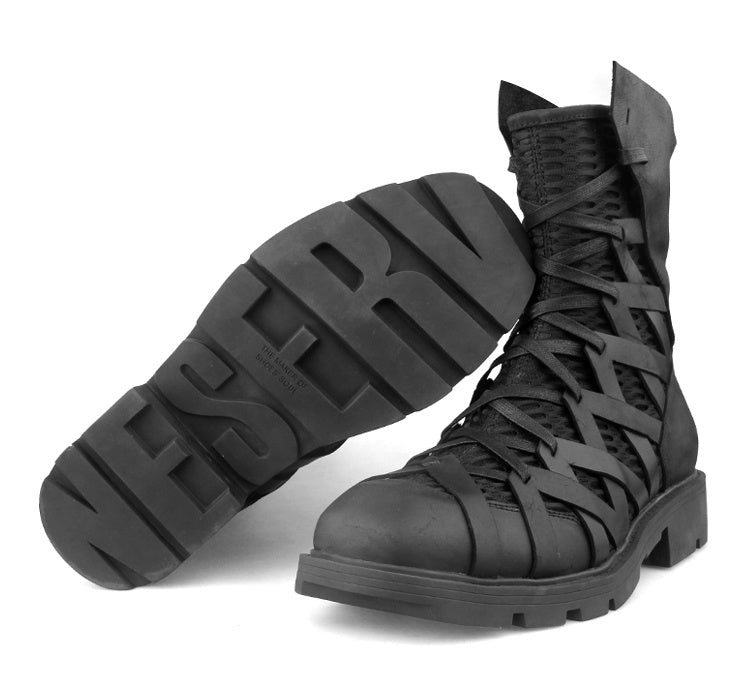 Black lace-up boots with 'WESTBY' branding on a white background